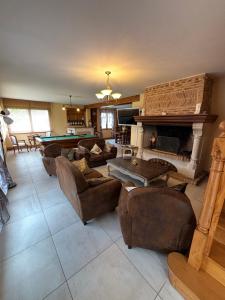 a living room with couches and a pool table at La Villa Boutrois in Isigny-sur-Mer