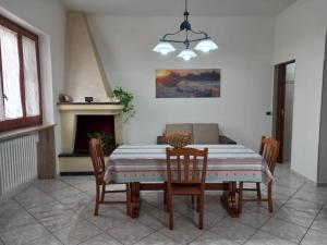 a dining room with a table and chairs and a fireplace at Le tre coccinelle in Porto Cesareo