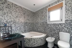 a bathroom with a tub and a toilet and a sink at La Casita de Alcabre in Vigo +10 photos