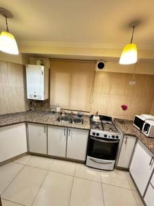 a kitchen with a stove and a sink at Lugones House in Cordoba +10 photos