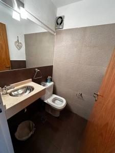 a bathroom with a sink and a toilet at Lugones House in Cordoba