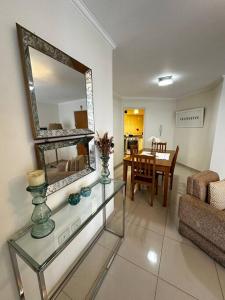 a living room with a table and a mirror at Lugones House in Cordoba