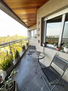 a balcony with chairs and a table on a balcony at Lugones House in Cordoba