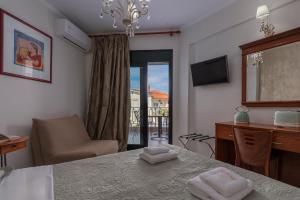 a room with a table and a chair and a desk at Paradise in Nea Vrasna
