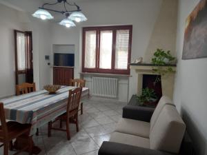 a living room with a table and a couch at Le tre coccinelle in Porto Cesareo
