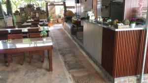 a restaurant with a table and chairs in a room at The Puji's Hostel in Batununggul +18 photos