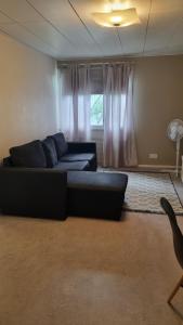a living room with a couch and a window at Sackle's place in Pori