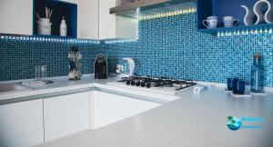 a kitchen with a sink and a stove top oven at BluSunset Home Capaci in Capaci
