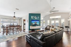a living room with a couch and a table at Charming Heated Pool Home - 3 miles to the Beach, Pet and Family Friendly -Available Year Round! in Bonita Springs