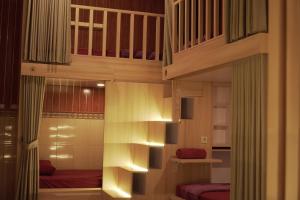 a bedroom with a loft bed with lights on it at The Puji's Hostel in Batununggul