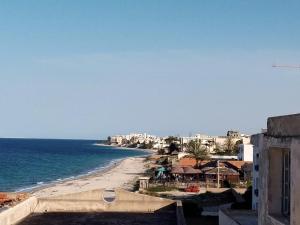 a view of a beach with buildings and the ocean at Résidence lalla baya appart 1 in Sousse