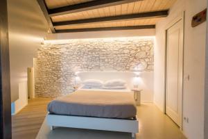 a bedroom with a bed and a stone wall at Villa Aruch in Florence