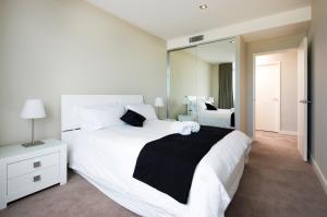 A bed or beds in a room at Claremont Quarter Luxury Apartment