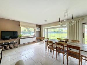a large living room with a table and chairs at Villa Sunny - Koksijde in Koksijde
