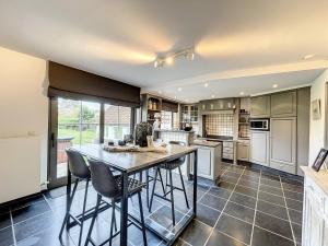 a kitchen with a table and some chairs in it at Villa Sunny - Koksijde in Koksijde