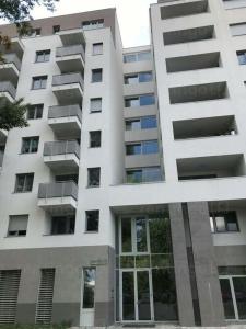 a large white building with balconies on it at Duna Apartment, FreeGarage, 2Room, smartTV,Dishwasher,AC in Budapest