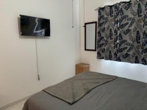 a bedroom with a bed and a tv on the wall at NEW Luxury Condo - In the heart of Santa Maria in Santa Maria