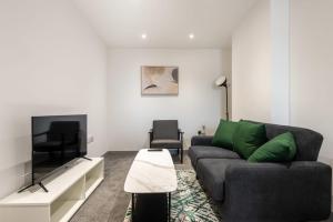 a living room with a couch and a tv at Perfect 1 Bed Budget Flat in Central Doncaster in Doncaster +5 photos