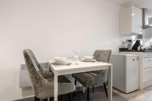 a kitchen with a white table and two chairs at Perfect 1 Bed Budget Flat in Central Doncaster in Doncaster