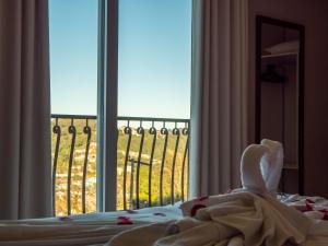 Cama ou camas em um quarto em Alameda Alegra Hotel
