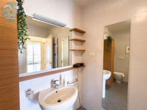 a bathroom with a sink and a mirror at Cattedrale 5 Tirabora Short Rent in Trieste +41 photos