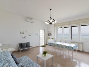 una sala de estar con un sofá y una mesa en Apartment Rome's Beach House 1 by Interhome, en Torvaianica