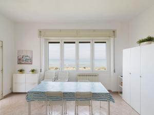 Un comedor blanco con una mesa y sillas. en Apartment Rome's Beach House 1 by Interhome, en Torvaianica 24 fotos más
