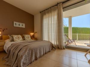 a bedroom with a bed and a large window at Apartment Viena 3 by Interhome in L'Ampolla