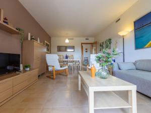 a living room with a couch and a table at Apartment Viena 3 by Interhome in L'Ampolla