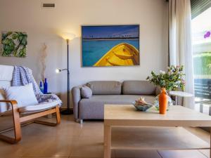 a living room with a couch and a table at Apartment Viena 3 by Interhome in L'Ampolla