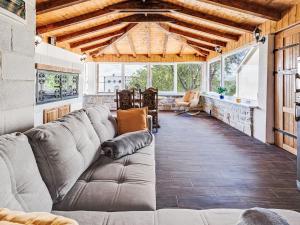 a living room with a large couch in a room with windows at Holiday Home Villa Frane by Interhome in Maslenica