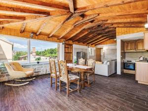 a kitchen and dining room with a table and chairs at Holiday Home Villa Frane by Interhome in Maslenica