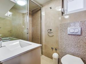 a bathroom with a sink and a shower at Holiday Home Villa Frane by Interhome in Maslenica