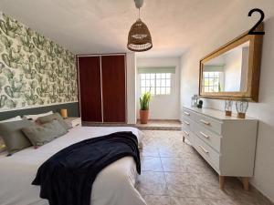 a bedroom with a bed and a dresser and a mirror at Buenavista in Breña Alta +26 photos