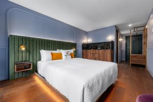 Postel nebo postele na pokoji v ubytování Hôtel Maurice