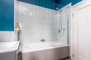 a bathroom with a shower and a tub and a sink at The Chancery in Dublin +9 photos