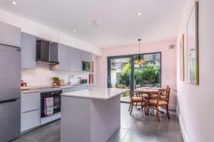 a kitchen with white cabinets and a table with chairs at The Chancery in Dublin
