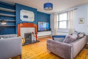 a living room with a couch and a fireplace at The Chancery in Dublin