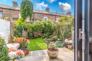 a garden outside a house with potted plants at The Chancery in Dublin