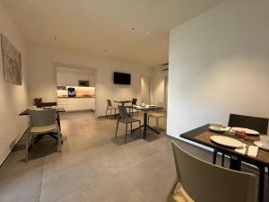 a kitchen and living room with tables and chairs at B&B Room47 in Alba Adriatica