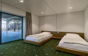 two twin beds in a room with a window at Black Sea Resort in Primorskoye +86 photos