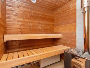 a wooden sauna with a bench in it at Holiday Home Kaislajärven huvila by Interhome in Risulahti