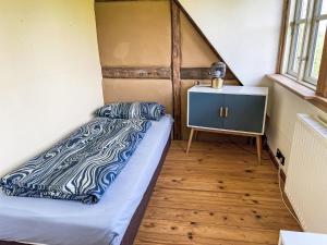 a small bedroom with a bed and a dresser at Holiday Home Eschengrund by Interhome in Alt Karin