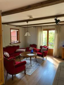 ein Wohnzimmer mit roten Stühlen und einem Tisch in der Unterkunft Bart’s loft in Älmhult + 3 Fotos