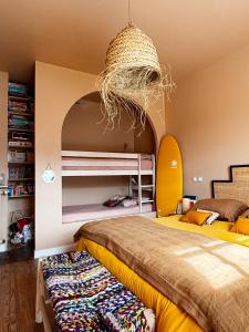 a bedroom with two bunk beds and a basket at La Casita in Mimizan