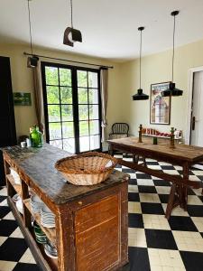 a kitchen with a table with a basket on it at La Casita in Mimizan +8 photos
