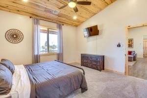 a bedroom with a bed and a ceiling fan at Near Hiking Trails Overgaard Home with Large Yard! in Overgaard