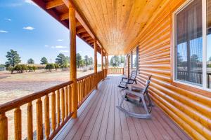 a porch with two rocking chairs on a house at Near Hiking Trails Overgaard Home with Large Yard! in Overgaard