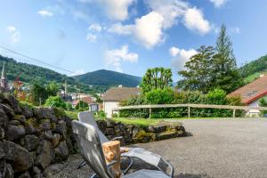 a chair sitting in front of a stone wall at Chalet La Sportive in Cornimont +13 photos