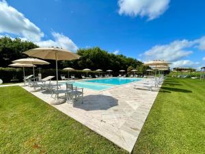 a swimming pool with chairs and umbrellas at LA RIMESSA EXPERIENCE-Dream Holiday Home in Montaione